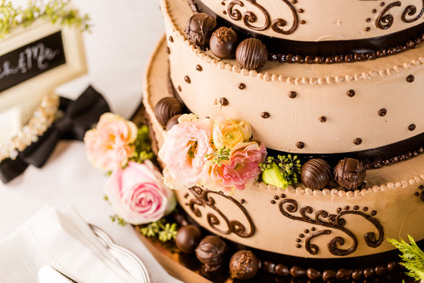 32870204 - gourmet tiered wedding cake at wedding reception.